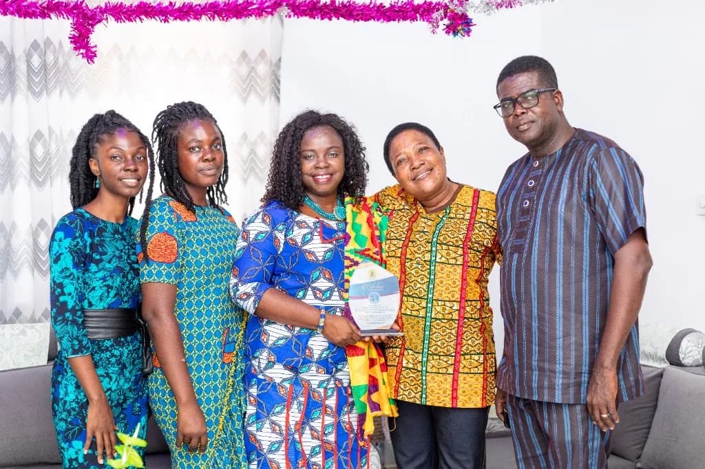 Standing with a citation award at Methodist Church, Shama-Junction.