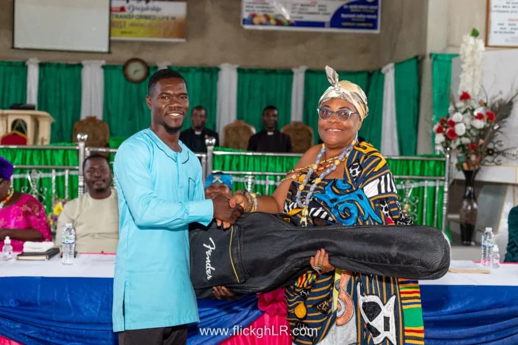 Presenting a guitar to support worship and music ministry.