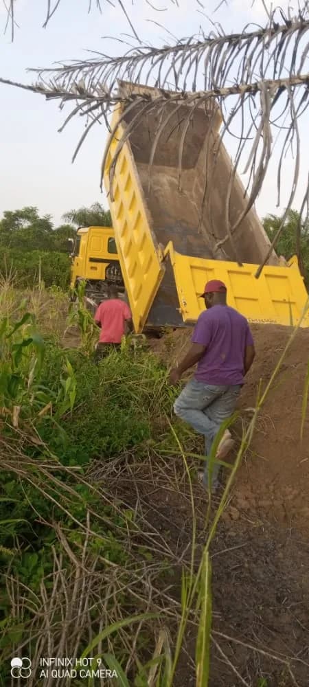 Delivery of sand for church construction — building materials provided by the Foundation.